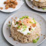 plate of filipino pork adobo fried rice topped with fried egg.