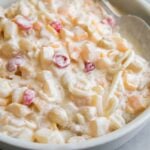 chilled Filipino fruit salad in large serving bowl with serving spoon.