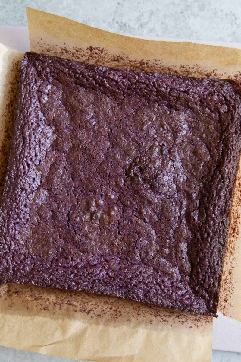 fudge ube brownies on parchment paper.