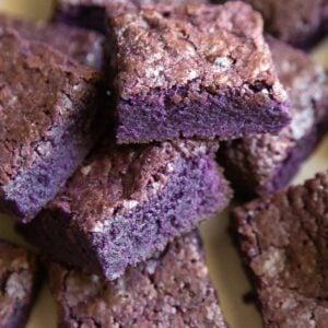 rich, dense, fudge ube brownies layered on top of one another.