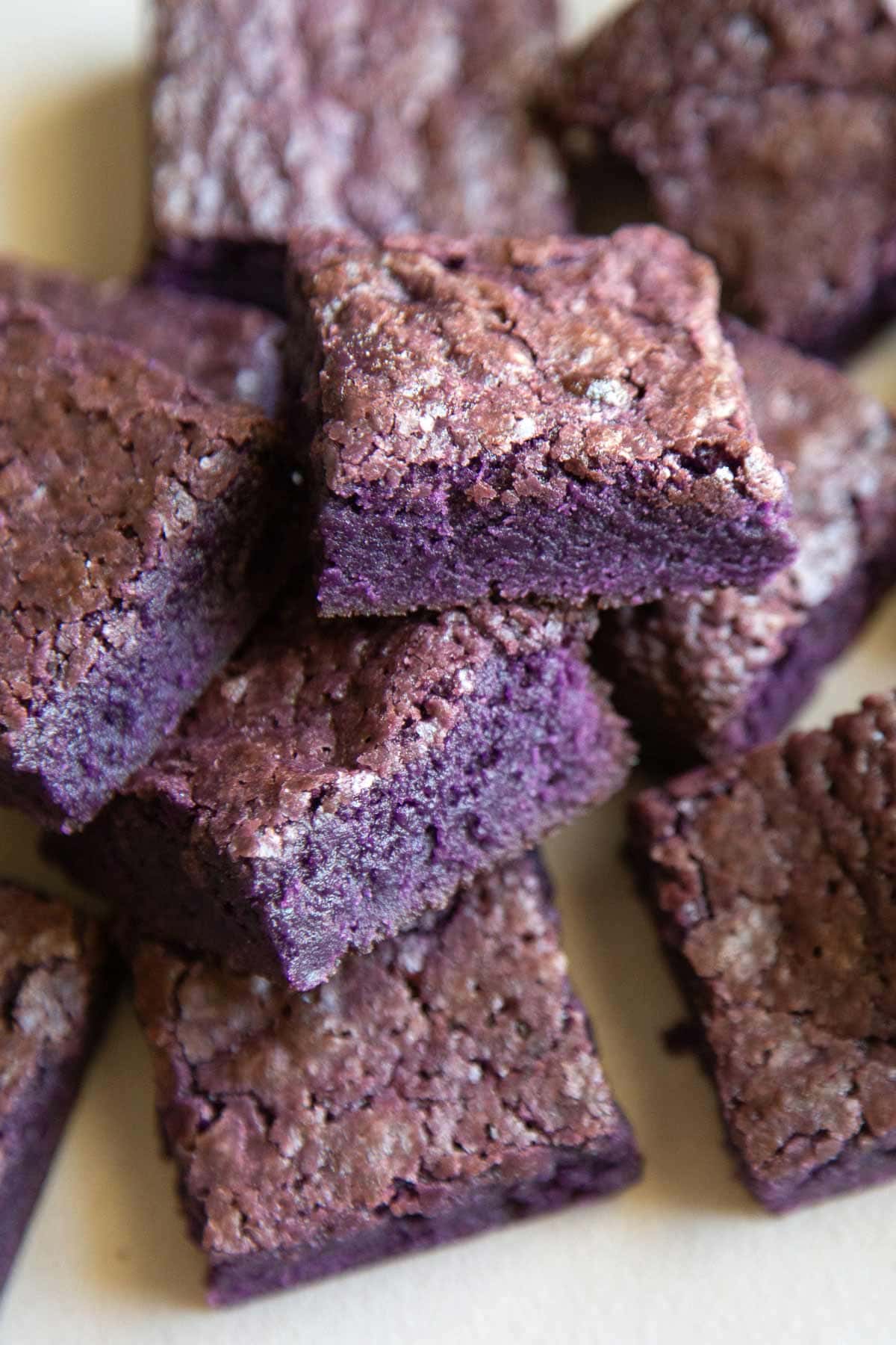 rich, dense, fudge ube brownies layered on top of one another.