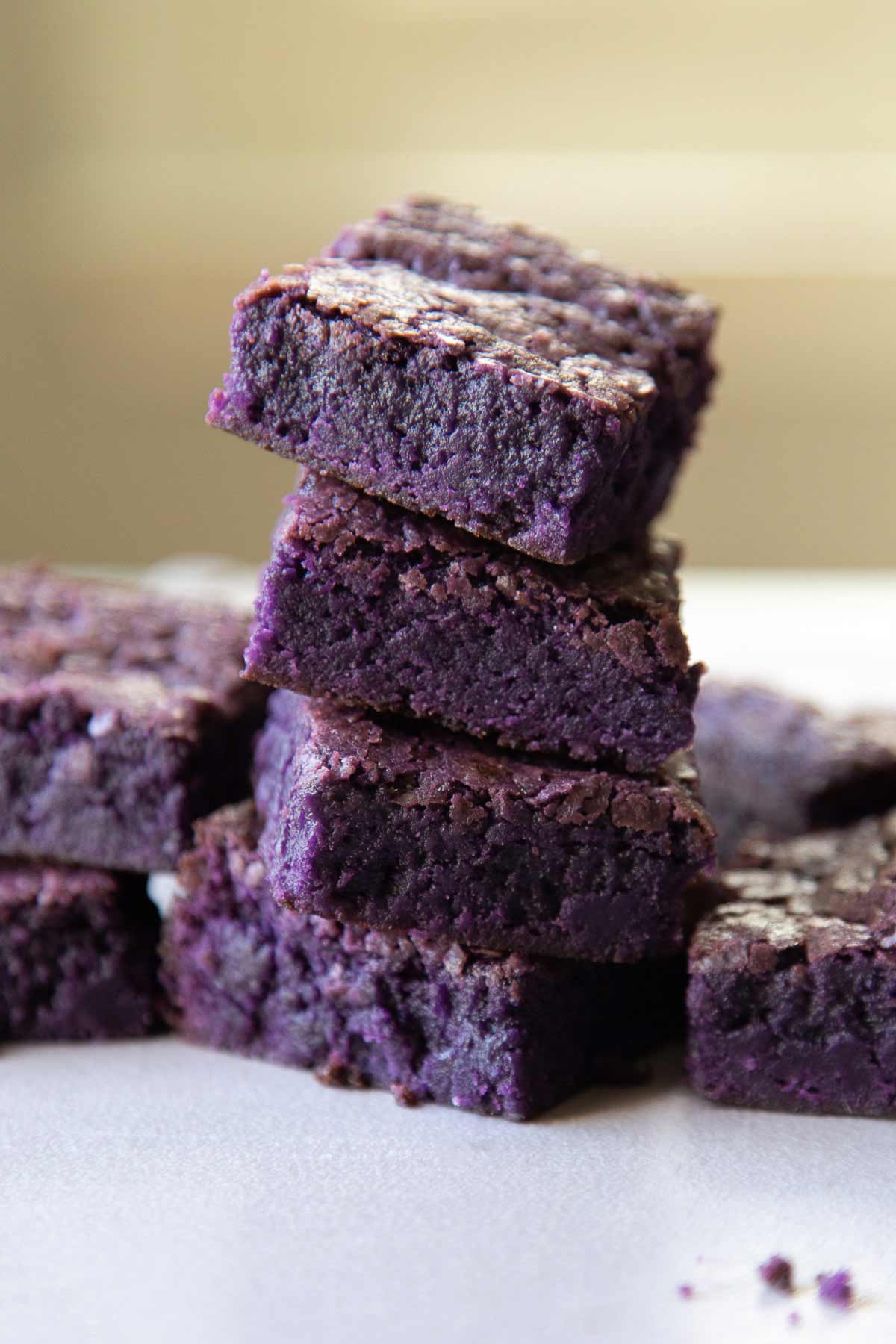 ube fudge brownie squares stacked.