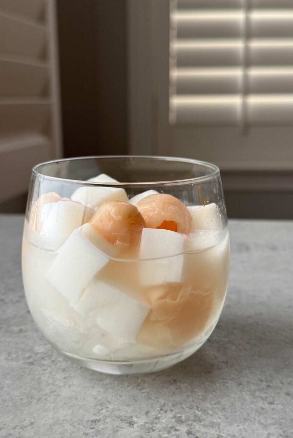 canned lychee and coconut almond jelly cubes in serving glass.