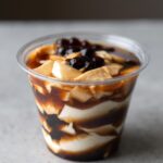 silken tofu and brown sugar tapioca layered in plastic cup.