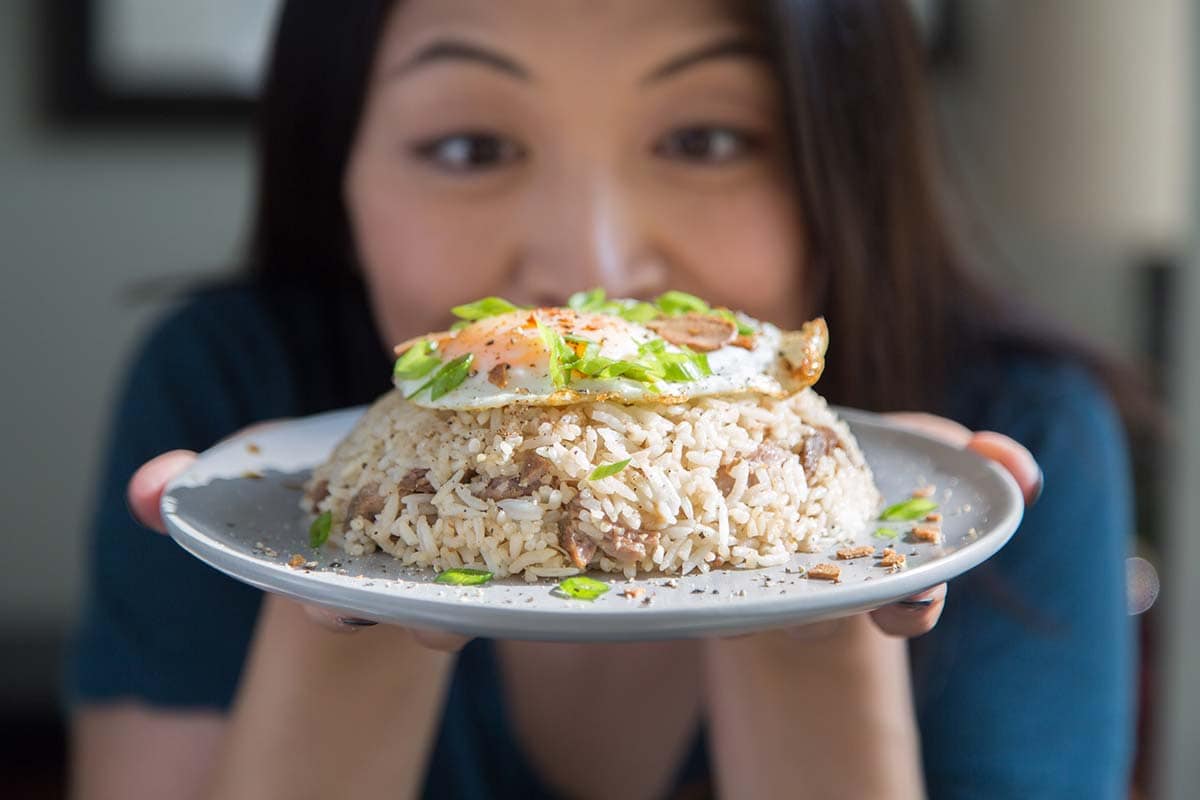 Maryanne Cabrera holding plate of adobo fried rice.