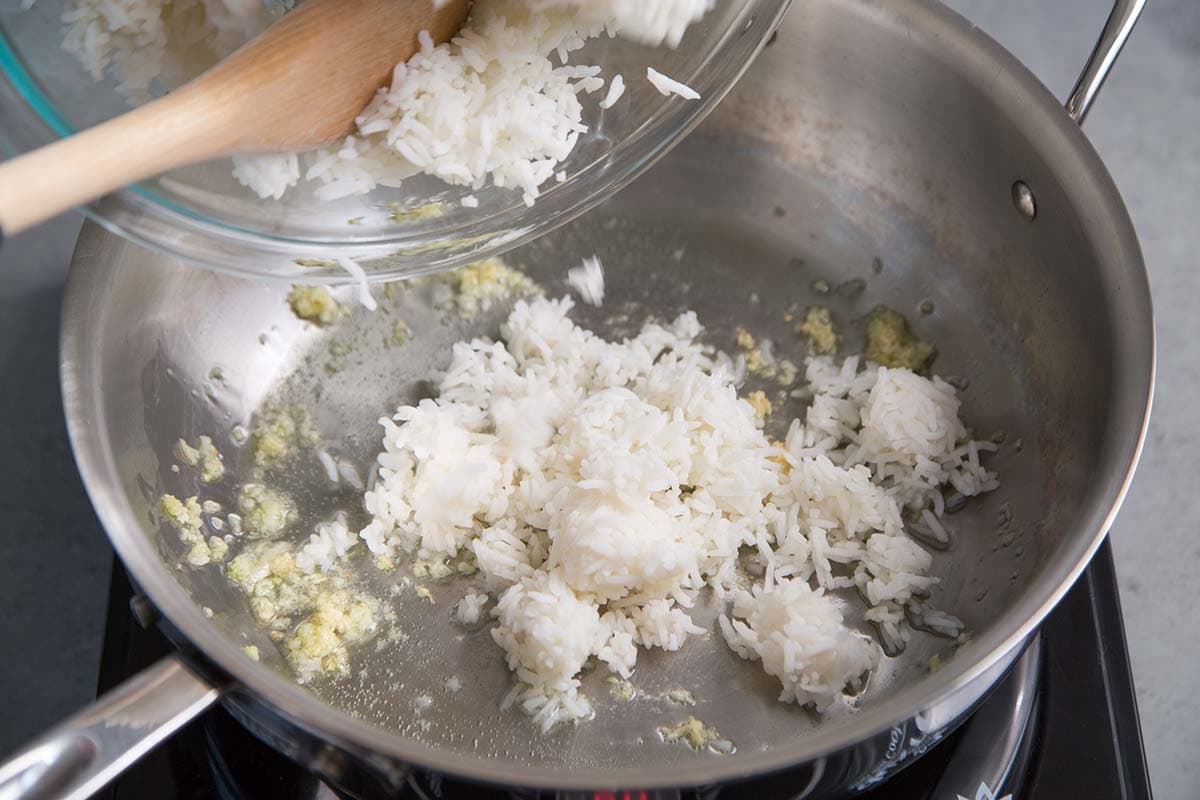 add cold rice to skillet with lightly cooked garlic.