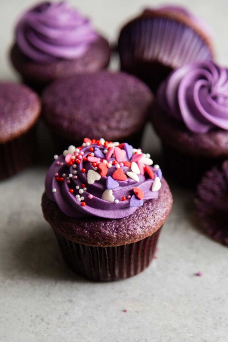 valentine sprinkle topped ube cupcakes with ube cream cheese frosting.