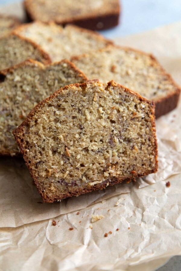 coconut banana bread slices on parchment paper.